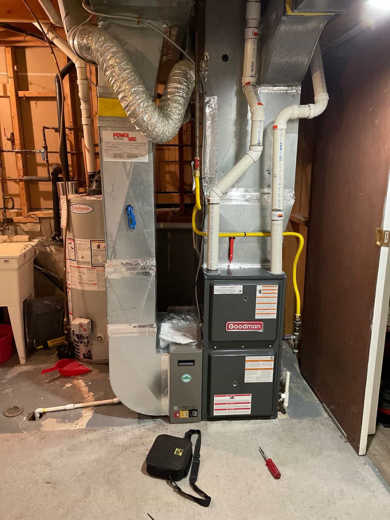 Goodman furnace tied into existing ductwork beside Reliance water heater